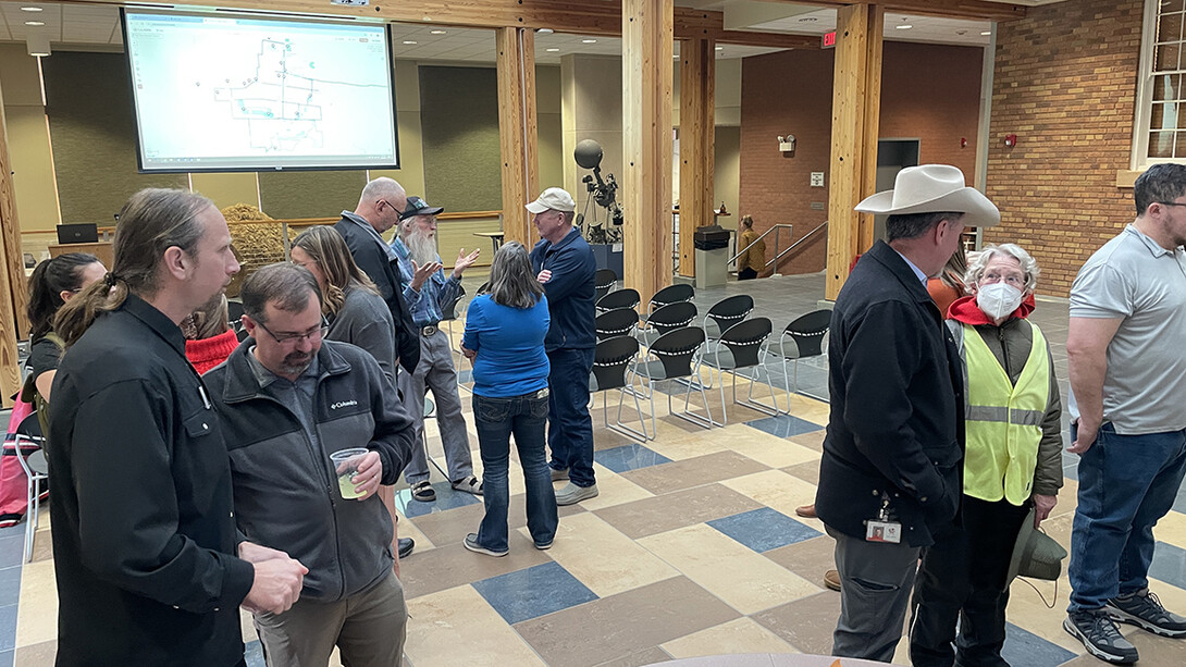 People gather in a room to discuss Chadron's "trail town" vision at an open house.