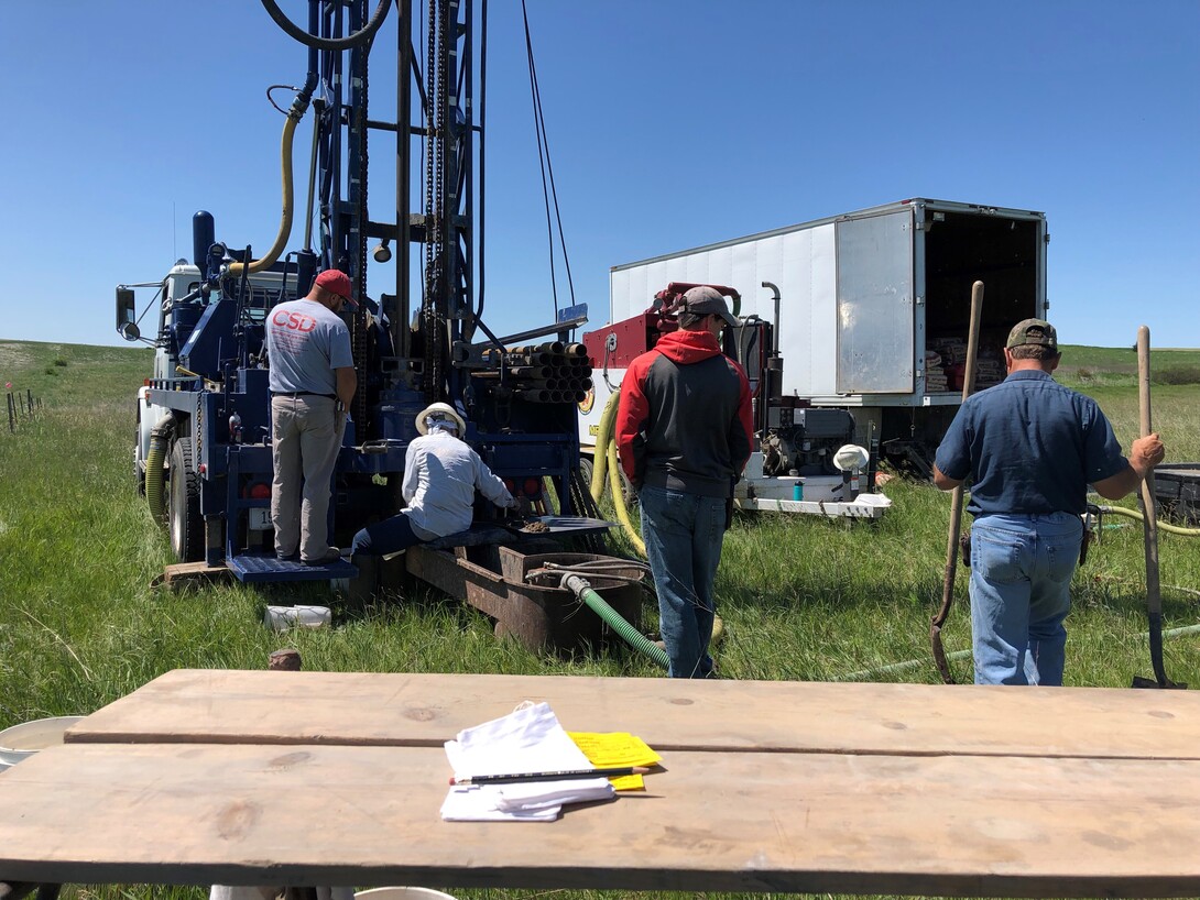 Crews drill a test hole for groundwater quality samples.