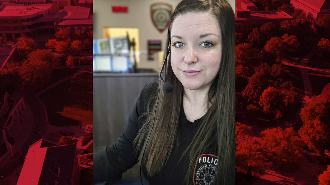 Photo of Alli Schultze sitting at a desk in UNLPD dispatch.