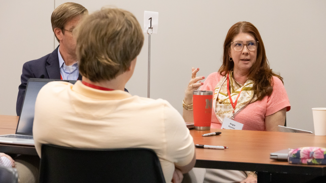 Angela Pannier, Swartz Family Chair of biological systems engineering, talks to colleagues during a breakout session.