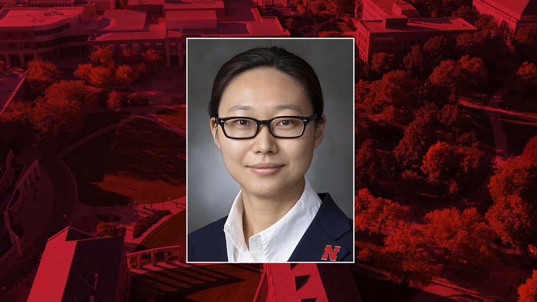 A headshot of Shuai in glasses and a white buttoned shirt.