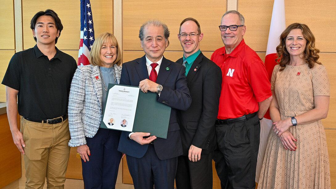 Group shot from a signing ceremony with Senshu University officials.