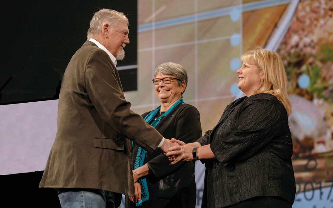 Richard Sutton (left) receives a research honor during the ASLA meeting on Oct. 23 from Vaughn B. Rinner and Elizabeth Miller.