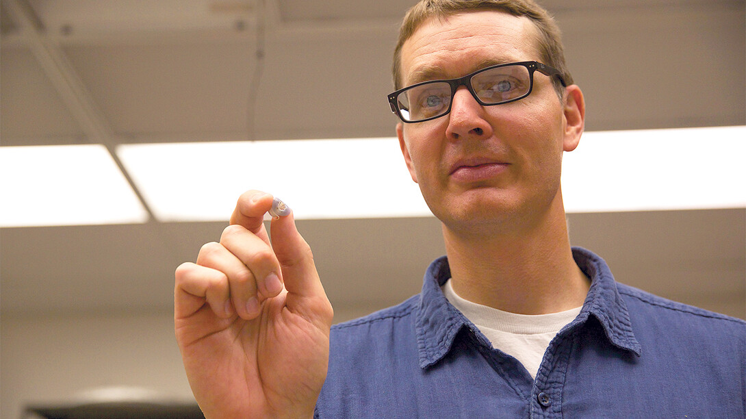UNL researcher Benjamin Terry holds a prototype of his team's tapeworm-inspired attachment mechanism, which adhered to the wall of a live intestine for six days.