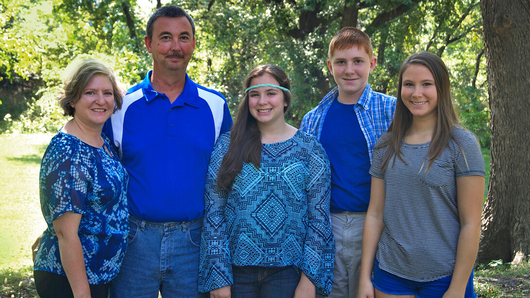 Marsha Yelden (left) stands with her husband and children.