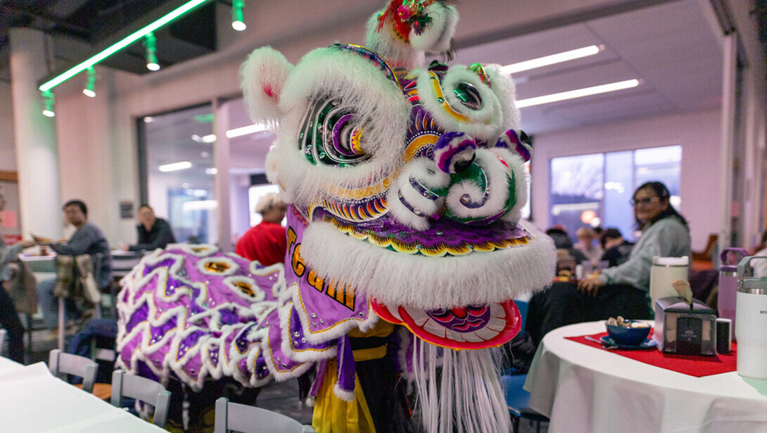 A mascot from the lunar new year makes its way through Cather Dining Hall.