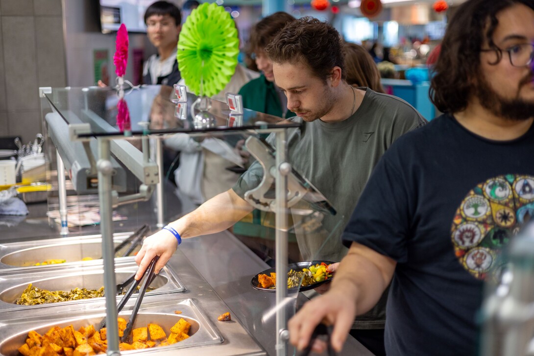 Students filling their plates at the Cather Dining Center