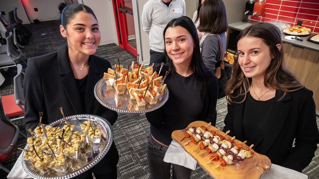 HRTM students Lake McClure, Paige Badura and Ava Matijasevich serve foods they prepared at the UNLimited Hospitality event in November 2025. (Photo by Loren Rye, Pixel Lab)