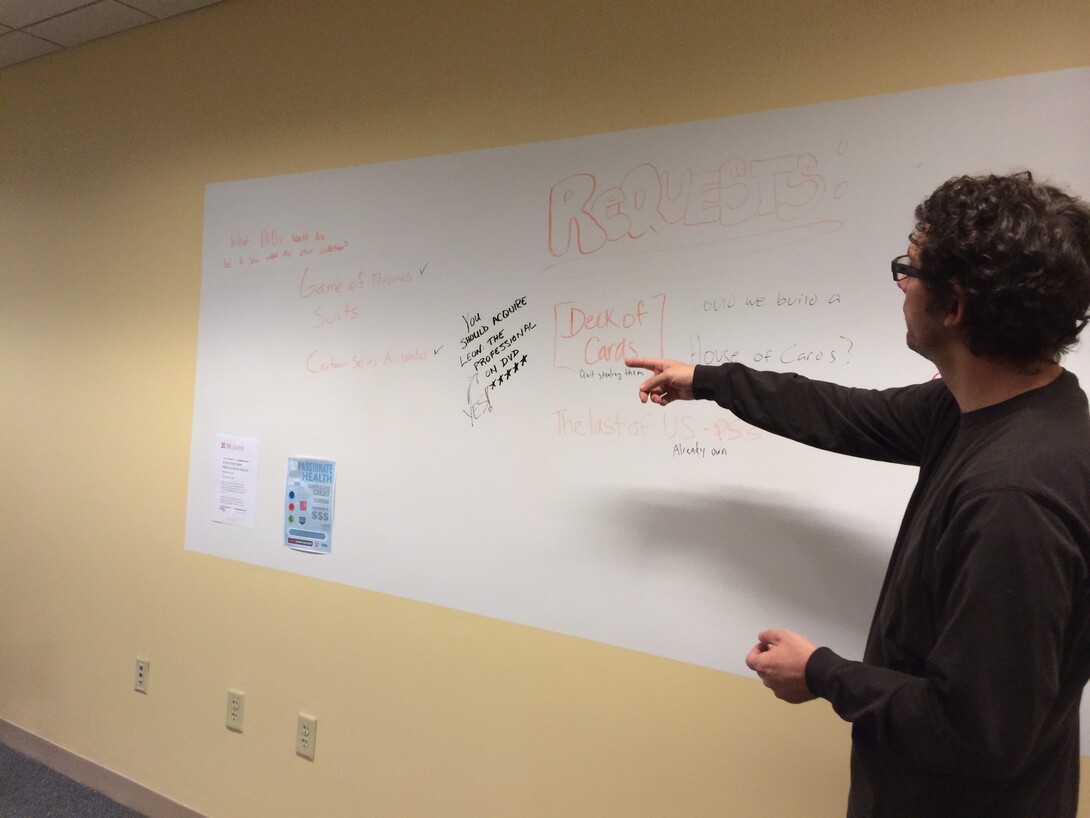 Richard Graham looks at the white board where library users make suggestions for new content.