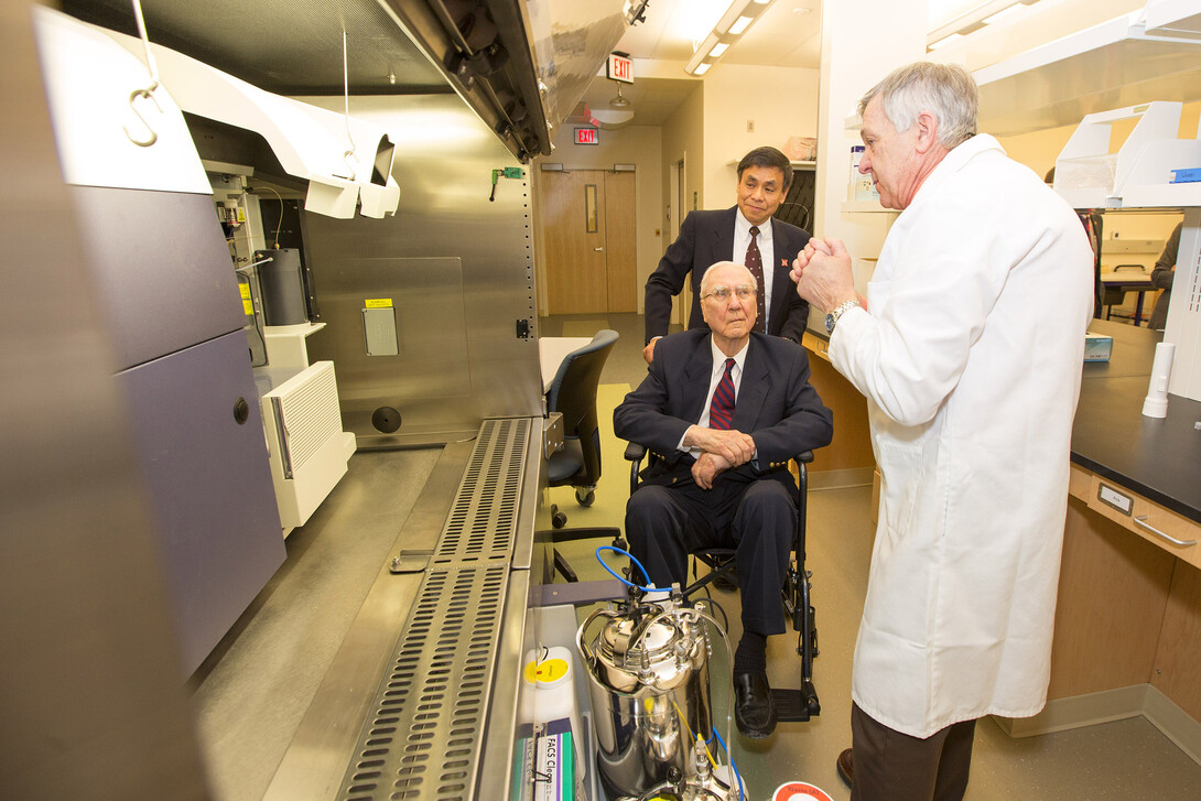 Ken Morrison, seated, and Charles Wood listen as Charles Kuszynski describes the new equipment and labs in the addition to the Morrison Life Sciences Research Center. Morrison was on hand to help cut the ribbon on the new addition. 