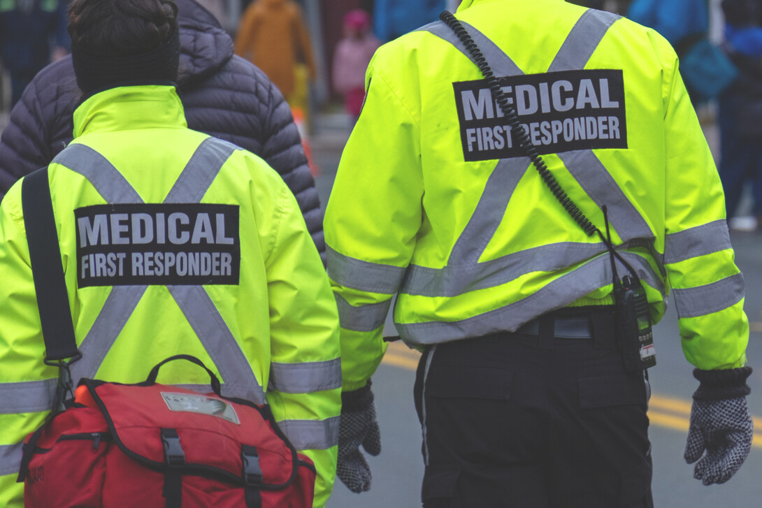 Emergency Medical Technicians approach a scene.