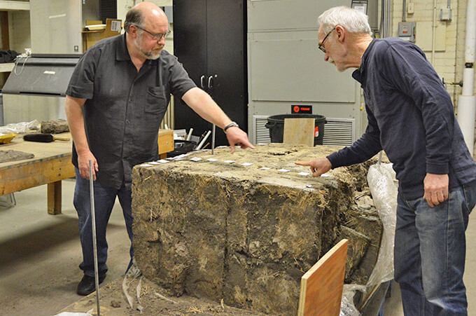 Professor of plant and ecosystem ecology Dave Wedin (left) and David Murphy, senior research architect at the Nebraska State Historical Society, with the sod wall. (Mekita Rivas | Natural Resources)